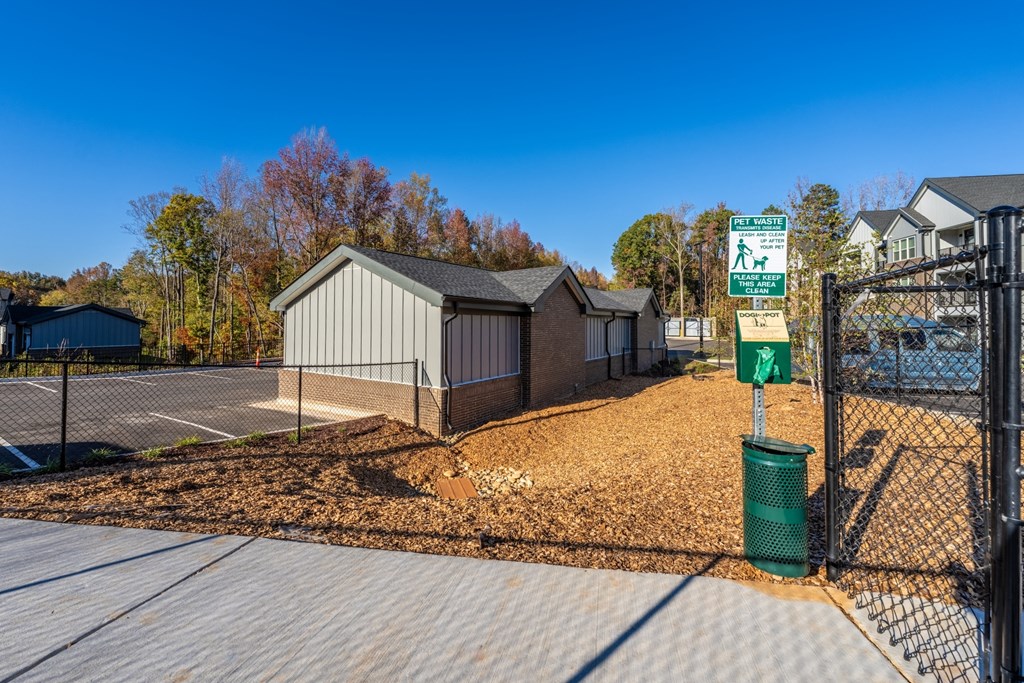 the entrance to a dog park with a chain link fence at Abberly Liberty Crossing Apartment Homes, Charlotte