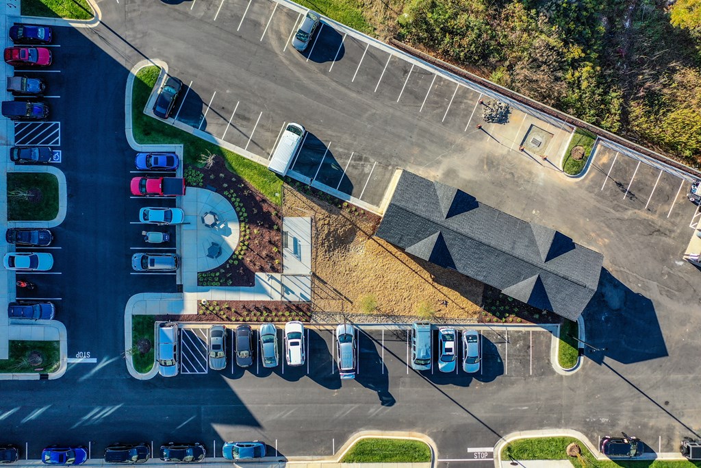 an aerial view of an parking lot with cars and a building at Abberly Liberty Crossing Apartment Homes, Charlotte, North Carolina