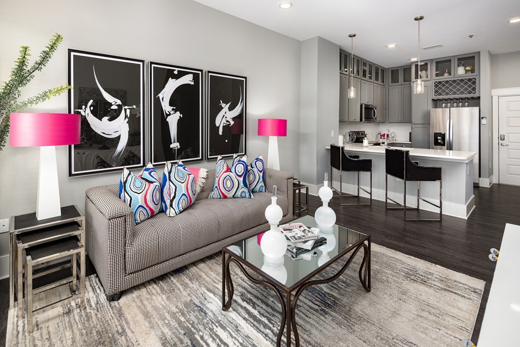 a living room with a couch and a glass table  at Abberly Onyx Apartment Homes, Decatur, Georgia