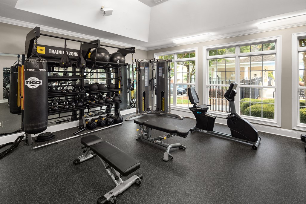 a home gym with weights and a punching bag at Abberly Grove Apartment Homes, North Carolina