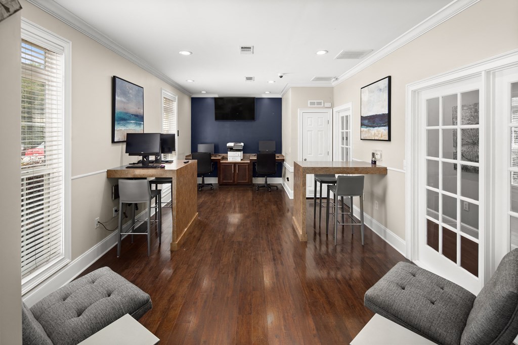 a common area with a desk and chairs and a flat screen tv at Abberly Grove Apartment Homes, Raleigh, NC