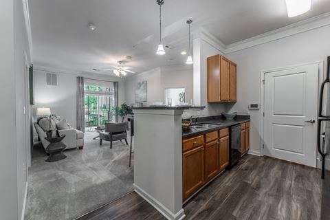 a kitchen and living room in a 555 waverly unit at Abberly Crest Apartment Homes, Lexington Park, 20653