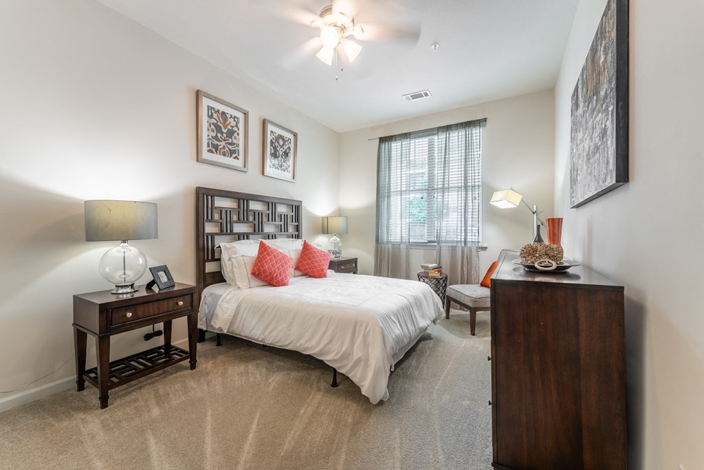 a bedroom with a bed and two night stands at Abberly Crest Apartment Homes, Lexington Park, Maryland