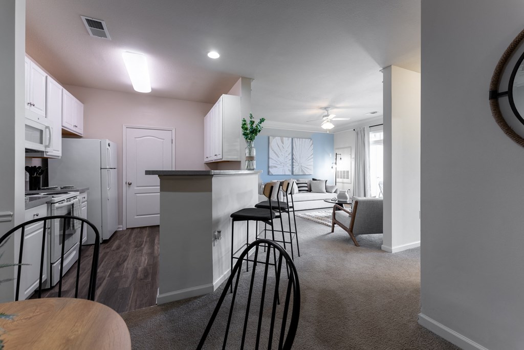a kitchen and living room in a 555 waverly unit at Abberly Crest Apartment Homes, Lexington Park, MD