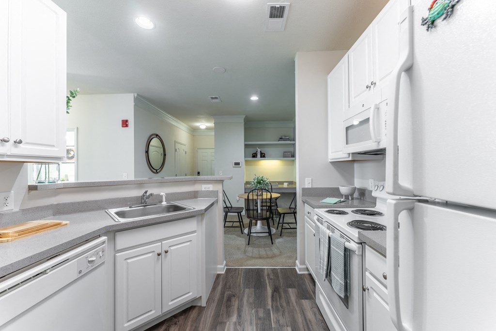 a kitchen with white cabinetry and a white stove top oven at Abberly Crest Apartment Homes, Lexington Park, MD, 20653