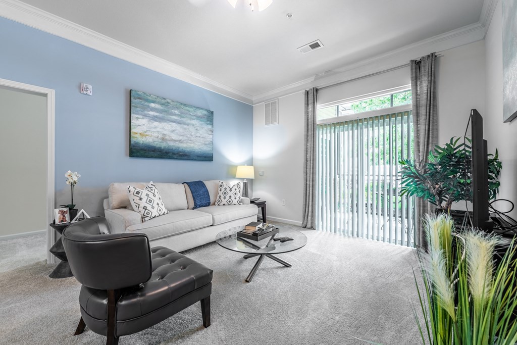 a living room with a couch and a chair at Abberly Crest Apartment Homes, Lexington Park
