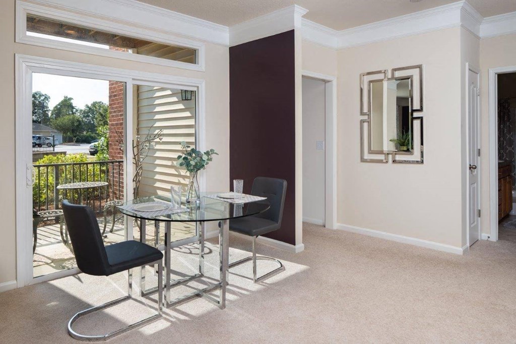 a dining room with a table and chairs at Abberly Crest Apartment Homes, Lexington Park, 20653