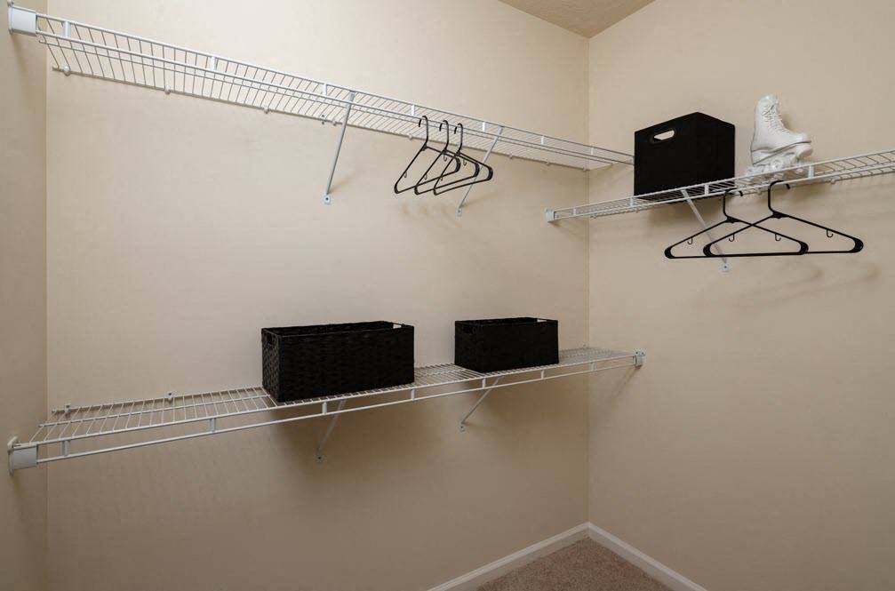 a walk in closet with shoe racks and a pair of sneakers at Abberly Crest Apartment Homes, Maryland, 20653