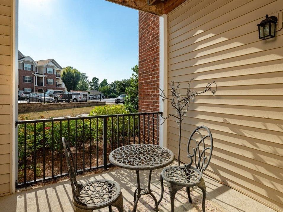 a patio with two chairs and a table  at Abberly Crest Apartment Homes, Lexington Park, Maryland