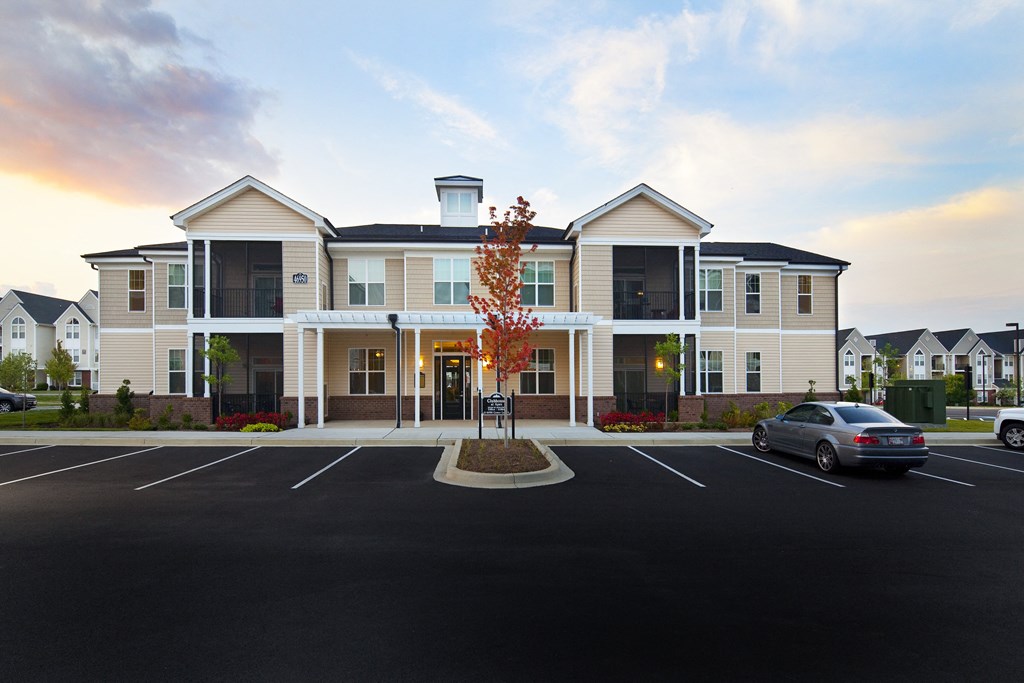 a large building with a car parked in front of it at Abberly Crest Apartment Homes, Lexington Park, 20653