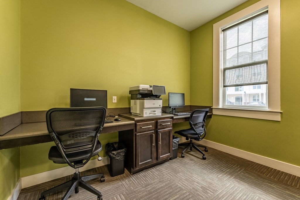 a room with two desks and two computer monitors at Abberly Crest Apartment Homes, Maryland