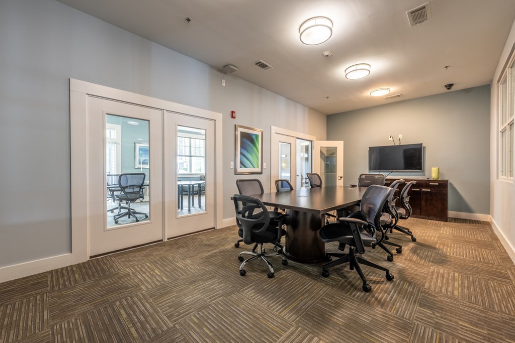 a conference room with a table and chairs at Abberly Crest Apartment Homes, Lexington Park, Maryland