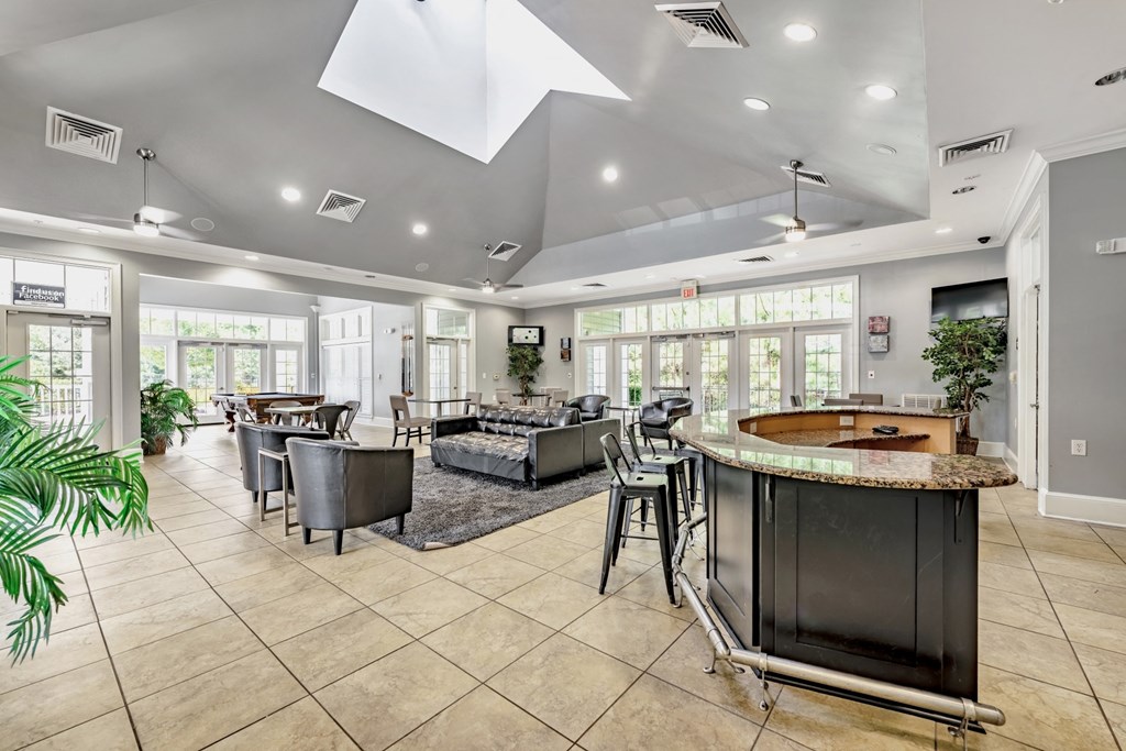 a resident clubhouse with a pool table and couches at Abberly Crest Apartment Homes, Lexington Park
