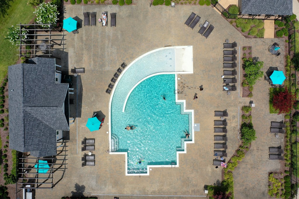 arial view of a resort pool with lounge chairs and umbrellas at Abberly Crest Apartment Homes, Lexington Park, 20653