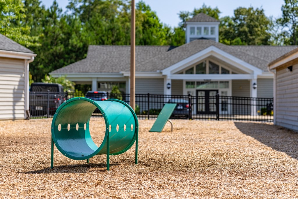 a playground with a green slide in front of a house at Abberly Crest Apartment Homes, HHHunt, Lexington Park, MD, 20653