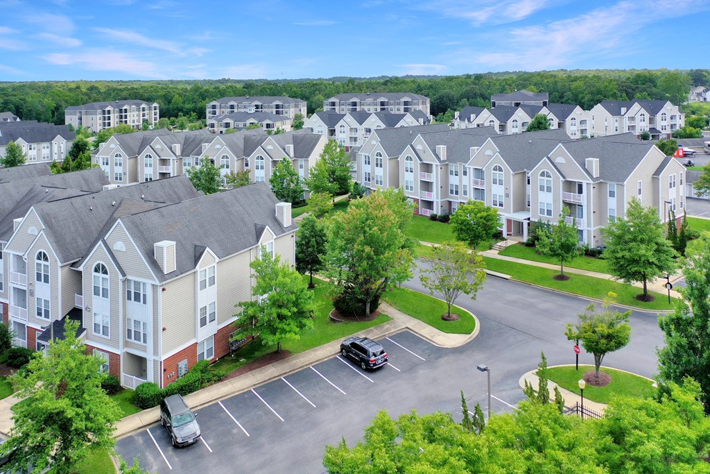 an aerial view of an apartment complex with a car parked in a parking lot at Abberly Crest Apartment Homes, Lexington Park