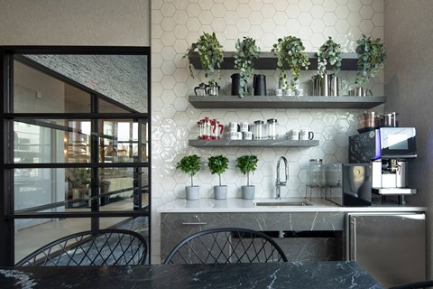 A kitchen with a marble table and a sink.