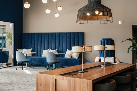 A modern living room with a blue sofa and a wooden table.
