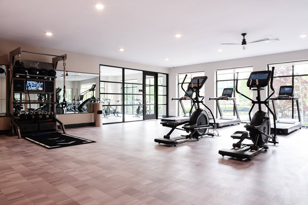 a home gym with exercise equipment and windows