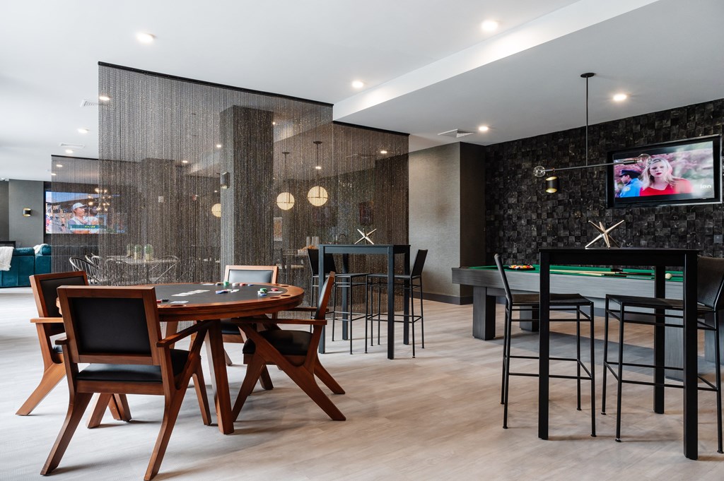 a dining room with tables and chairs and a pool table