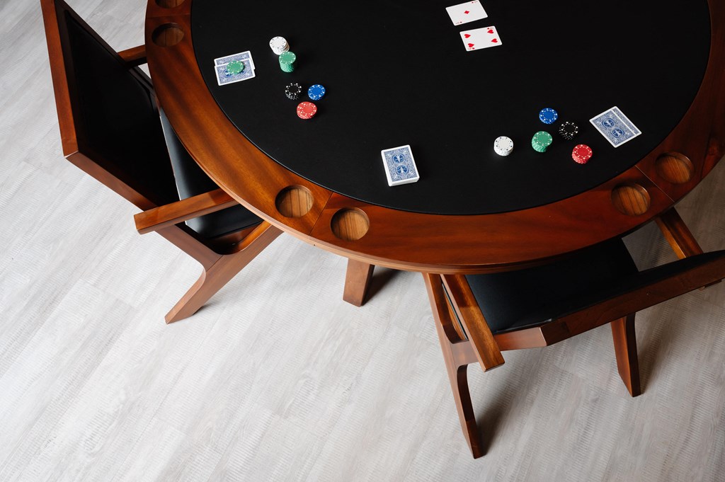 a wooden table with a black table top and wooden chairs