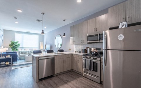 A modern kitchen with stainless steel appliances and wooden cabinets.