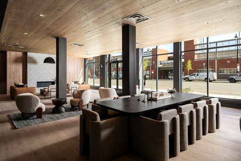 A modern dining room with a long table and chairs.