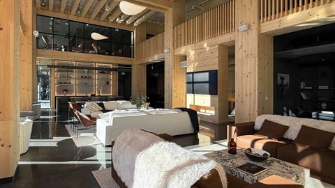 A modern living room with a white couch and a wooden ceiling.