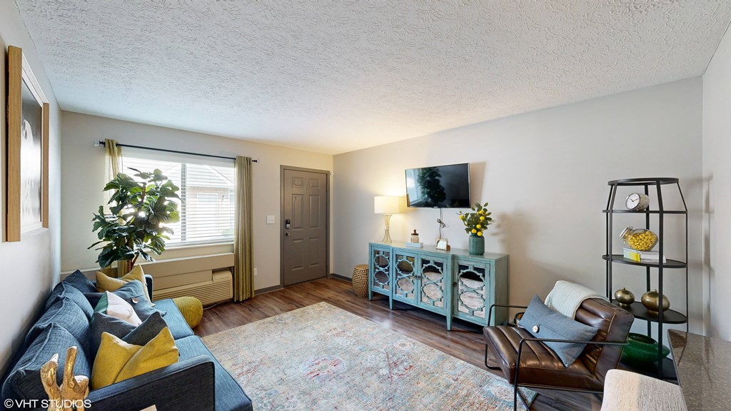a living room with a couch and a tv at Springburne at Polaris Apartments, Columbus, Ohio