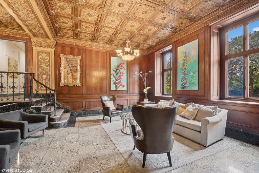 the living room has ornate wood paneling and a marble floor  at The Embassy in St. Louis, 63108