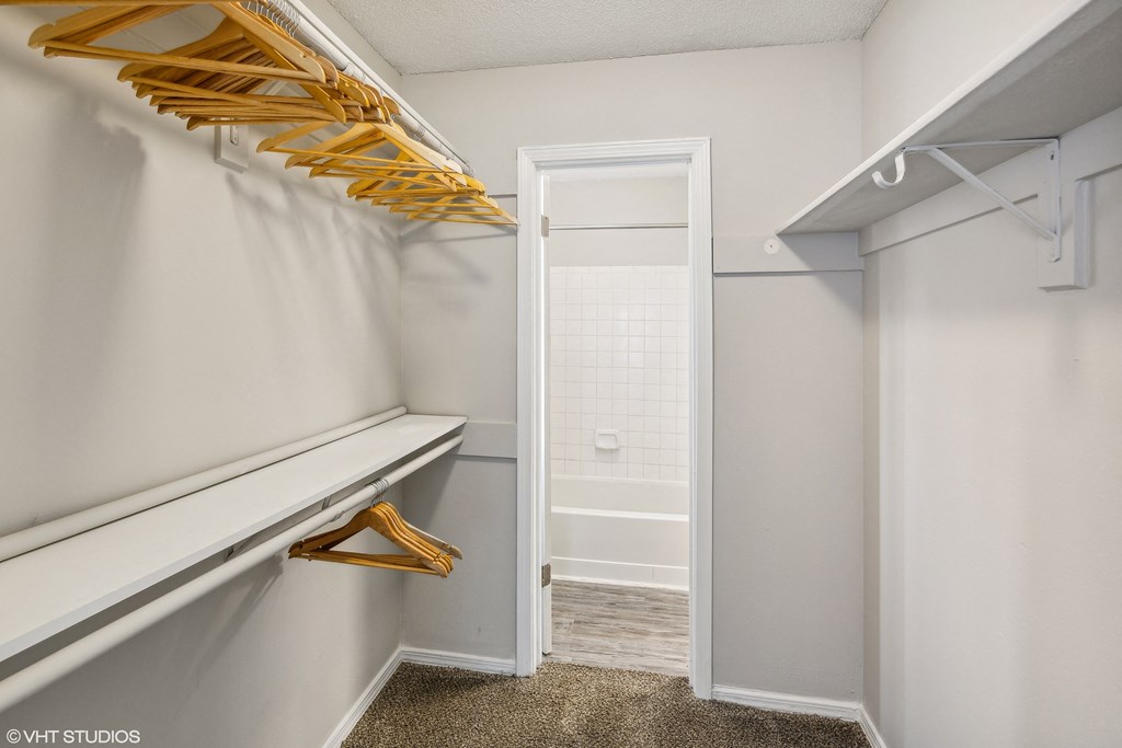 a walk in closet with white walls and white closet doors and a white closet door at The Local Apartments, Tennessee