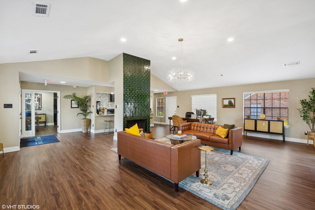 a living room with a leather couch and a fireplace at The Birches Apartment Homes, Memphis, TN, 38133