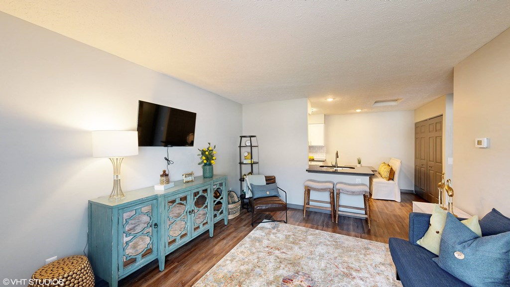 a living room with a couch and a tv at Springburne at Polaris Apartments, Columbus, OH, 43235