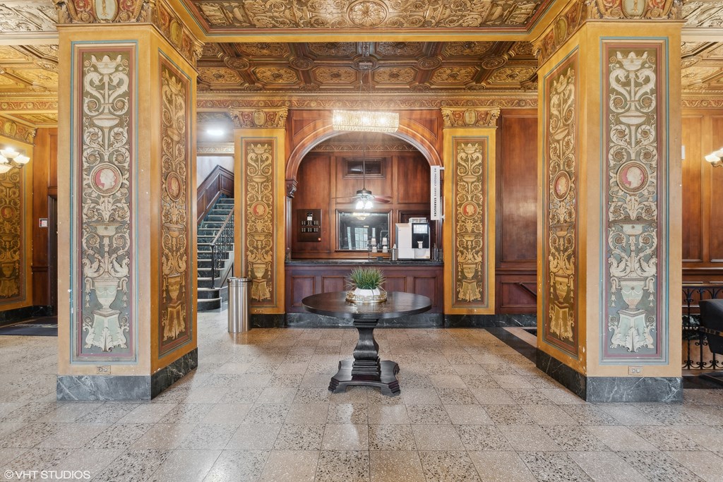 a lobby with a table in the middle of a room at CWE Apartments, St. Louis, 63108
