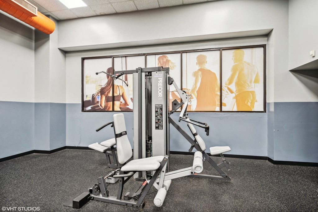 a gym with weights and cardio equipment in a building a gym with weights and cardio equipment in a building at Delmar Loop Apartments, Missouri