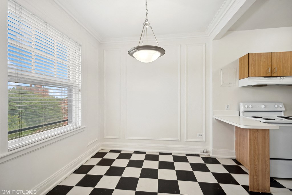 a kitchen with a checkered floor and a window  at The Embassy in St. Louis, 63108