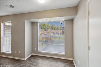 an empty living room with a large window at The Birches Apartment Homes, Tennessee