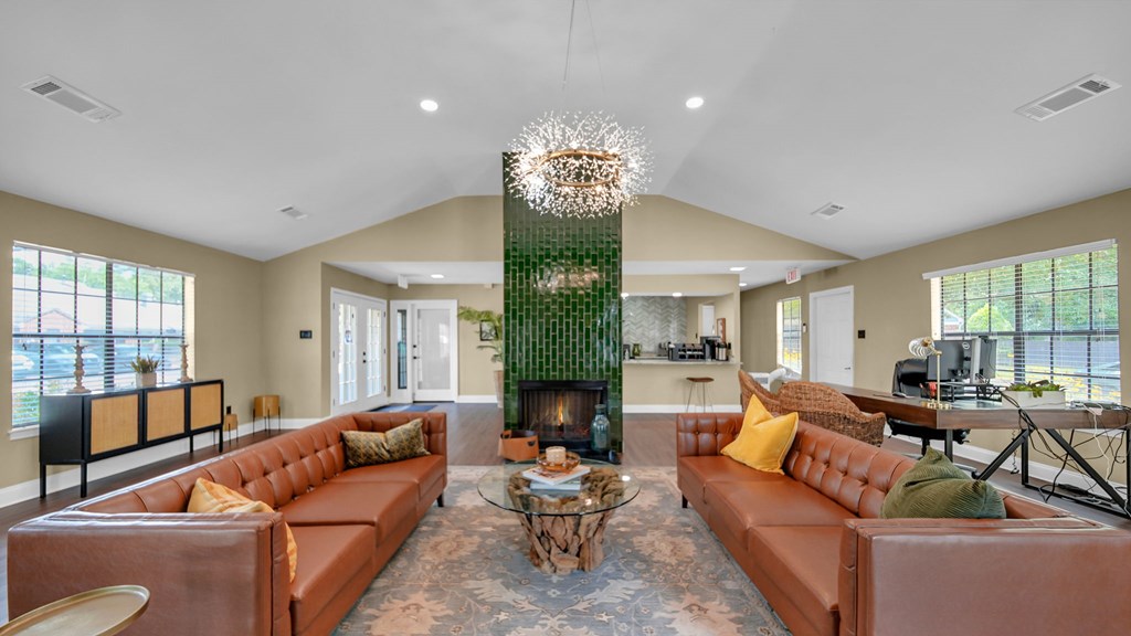 A living room with a fireplace and a chandelier.