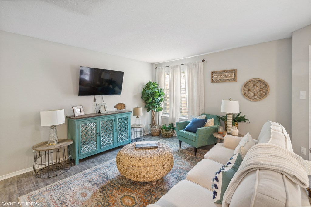 a living room with a couch and a tv at The Local Apartments, Memphis