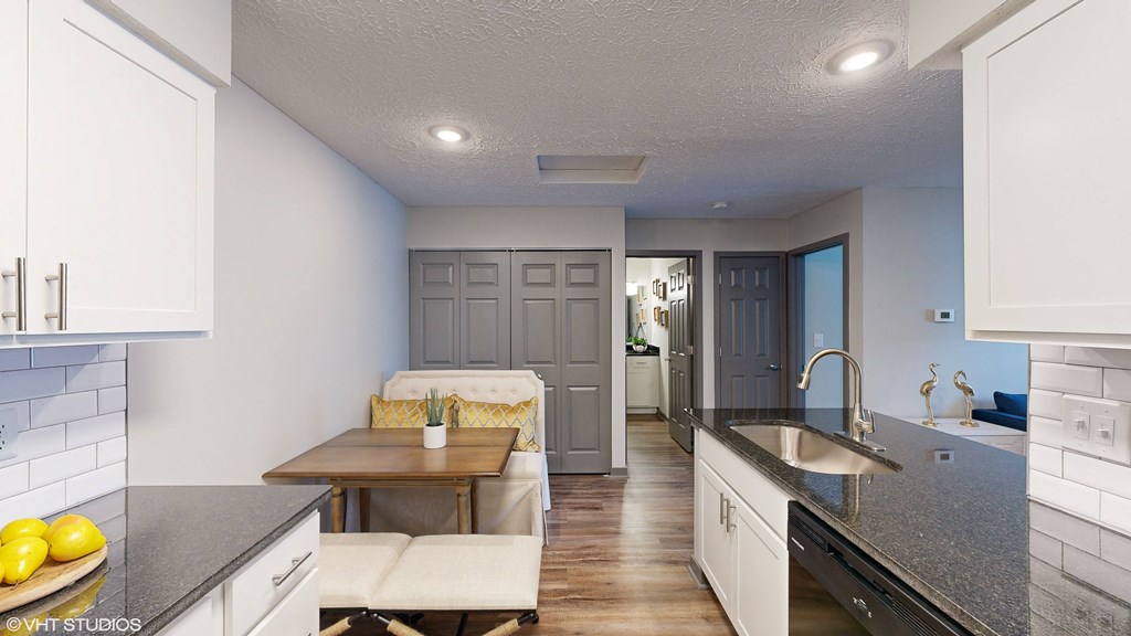 a kitchen with white cabinets and a counter top and a sink at Springburne at Polaris Apartments, Columbus, 43235