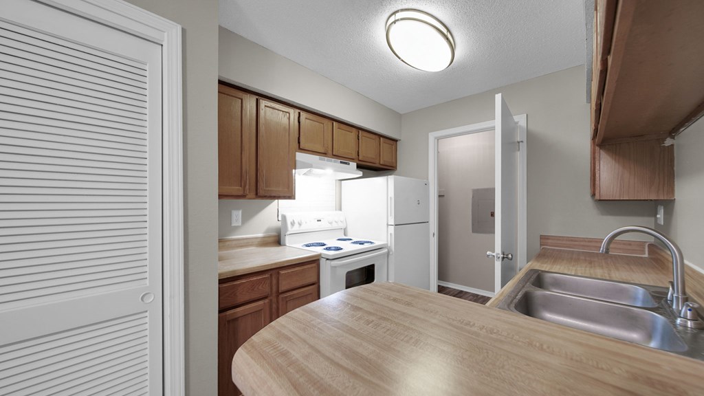 A kitchen with wooden countertops and white appliances. at The Local Apartments, Memphis, TN, 38115