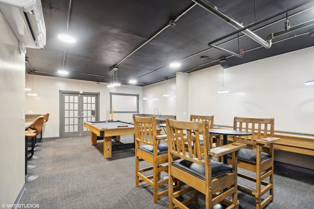 a game room with tables and chairs and a pool table at CWE Apartments, St. Louis, MO, 63108