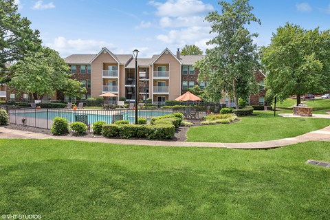 commons apartment community pool and grass commons apartment community pool and grass at The Local Apartments, Memphis, TN