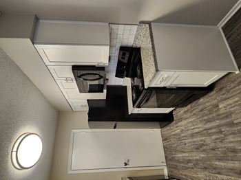 an overhead view of a small kitchen with a microwave and a sink