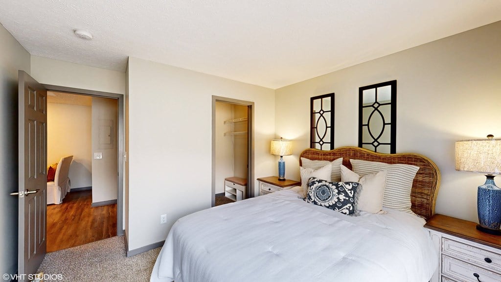 a bedroom with a large bed and a closet a bedroom with a large bed and a closet at Springburne at Polaris Apartments, Columbus