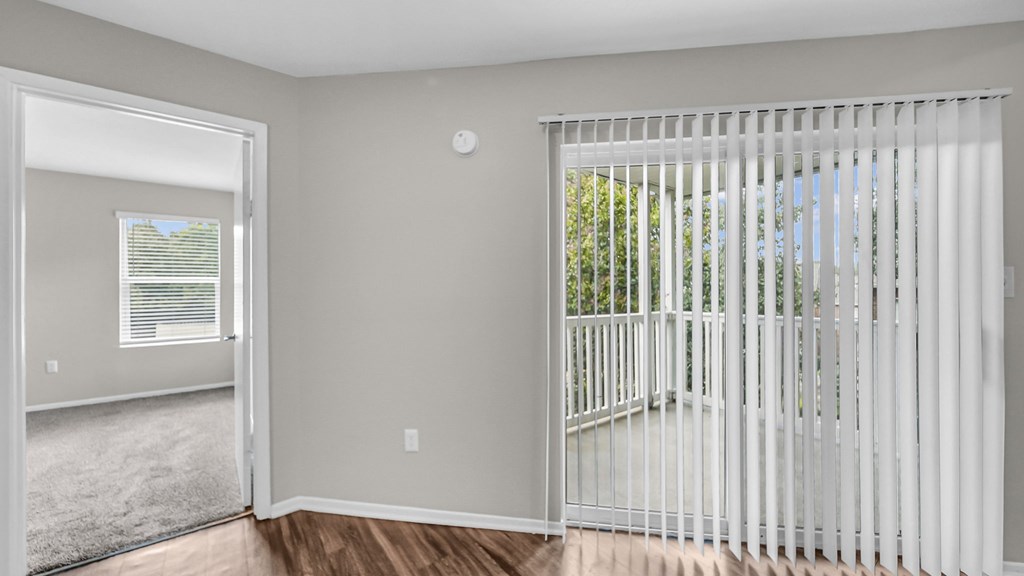 A room with a white gate and a window with blinds.