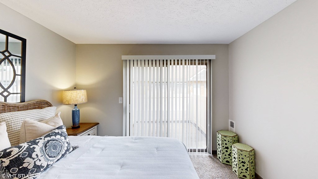 a bedroom with a bed and a large window at Springburne at Polaris Apartments, Ohio