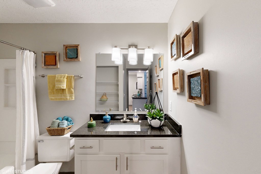 a bathroom with a sink and a mirror and a shower at Springburne at Polaris Apartments, Columbus, OH, 43235