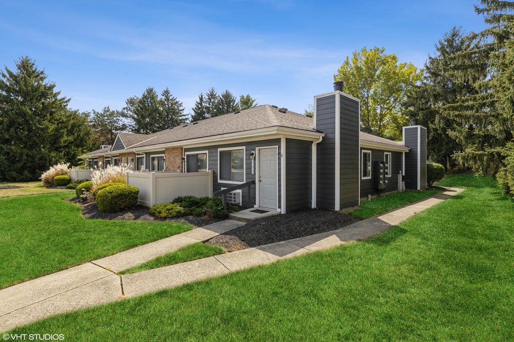 a small gray house with a sidewalk in front of it at Springburne at Polaris Apartments, Columbus, OH