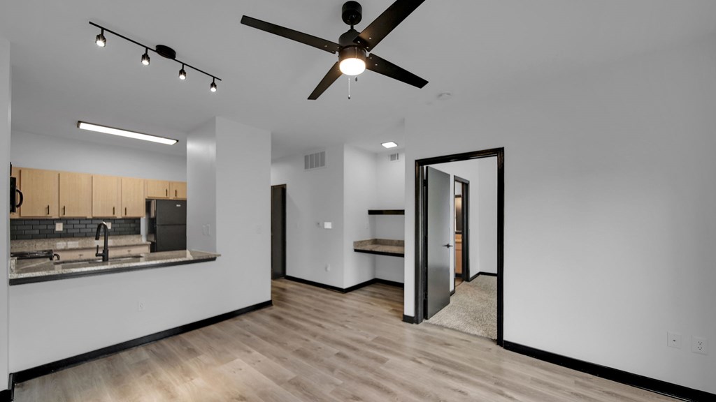 A modern kitchen with a ceiling fan and a countertop with a sink.